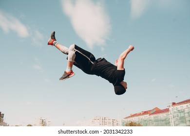 Young sporty guy doing parkour at the city street - Powered by Shutterstock