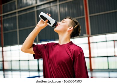 Young Sporty Man Drinking Sporty Drink Or Water