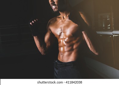 Young Sporty Man In The Gym. Male Boxer. Training. Close Up Man Body