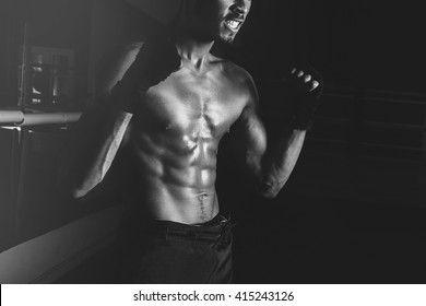 Young Sporty Man In The Gym. Male Boxer. Training. Close Up Man Body