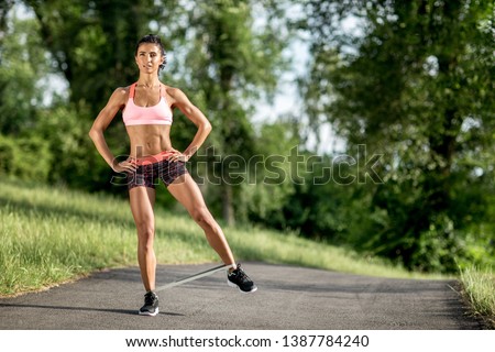 Similar – Fit muscular woman working out in a park