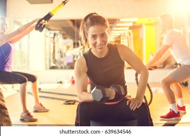 Young Sporty Woman Lifting Weights At Gym.