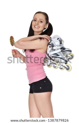 Young  sporty woman with rollerskates and lollipop  on a white background.