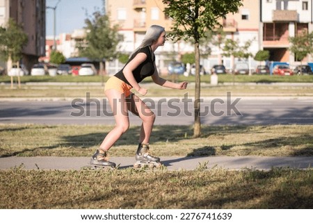 Similar – Young man riding on skate and holding surfboard