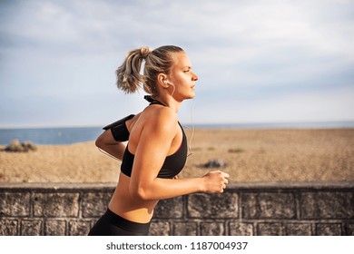 Young Sporty Woman Runner Running Outside On A Beach In Nature.