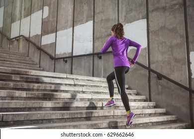 Young Sporty Woman Running Upstairs