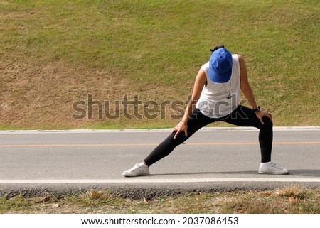 Similar – Athlete at the city park warming and stretching