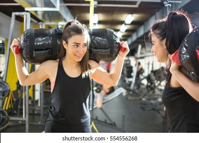 Young Sporty Women Carrying On Fitness Bags On Shoulders At Gym.