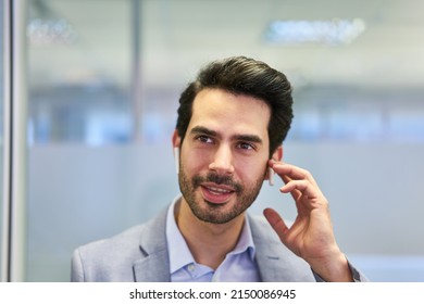 Young Start-up Business Founder Listens To Positive News With Wireless Headset In The Office