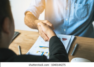 young startup businessman shaking hands with partners after agree a deal to collaborate.