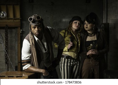 Young Steam Punks PosIng in Underground Lair