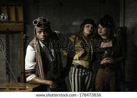 Young Steam Punks PosIng in Underground Lair