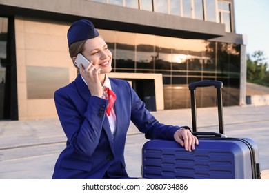 Young Stewardess Talking By Phone Outdoors