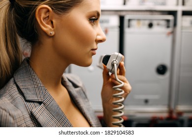 Young Stewardess Talking On Phone In The Airplane.