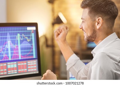 Young Stock Exchange Trader Working In Office