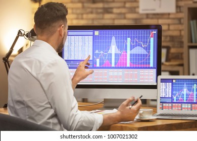 Young stock exchange trader working in office - Shutterstock ID 1007021302