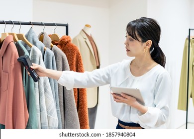 Young Store Clerk Reading Data Of Clothes. Inventory Management. Stocktaking. RFID.