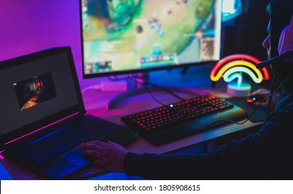 Young streamer gamer playing at strategy game in broadcast browser - Male guy having fun gaming and streaming online - New technology game trends and entertainment concept - Focus on his nose