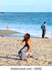 Young street performer juggeling on a California Beach