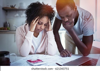 Young Stressed African American Couple In Trouble, Have No Money To Pay Debts,  Rent For Appartment. Wife Holding Head In Despair, Having Financial Troubles. Household Budget 