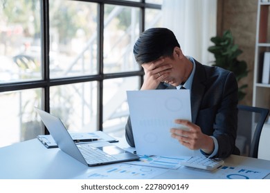 Young stressed Asian businessman working in the office. Businessman thinking too much work concept in the office. - Shutterstock ID 2278090149