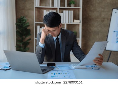 Young stressed Asian businessman working in the office. Businessman thinking too much work concept in the office. - Shutterstock ID 2278090151