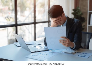 Young stressed Asian businessman working in the office. Businessman thinking too much work concept in the office. - Shutterstock ID 2278090159