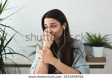 Young stressed and depressed woman talking on video call with her psychotherapist on online therapy from her home open her hart and confess everything that make her sad and miserable