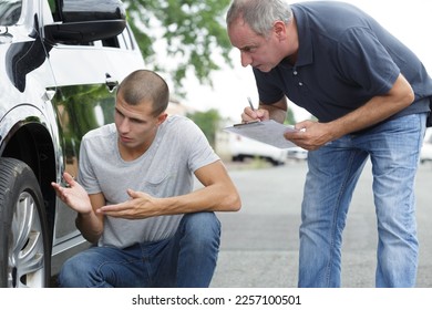 young stressed man having trouble with his broken car - Shutterstock ID 2257100501
