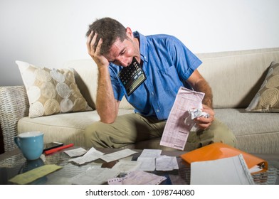 Young Stressed And Overwhelmed Man Biting Calculator Holding Mess Of Bank And Receipts Paperwork Desperate Calculating Monthly Expenses Taxes And Income Frustrated In Domestic Accounting