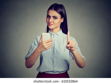 Young Strict Woman With Smartphone Showing No, Don't, Attention With Finger Hand Gesture. Blocking Adult Contents, Parental Control Concept