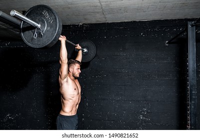 Young Strong Fit Muscular Sweaty Man With Big Muscles Doing Barbell Weight Lifting Cross Training Workout In The Gym Dark Image Real People