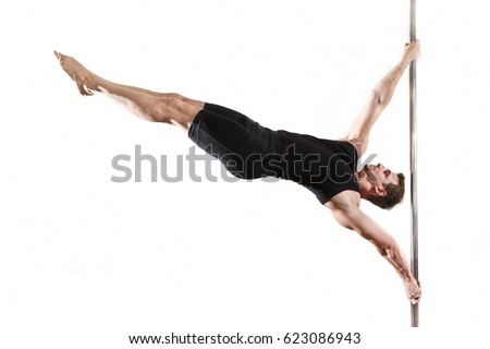 Young strong pole dancer smiling man in black clothes on pylon. White background.