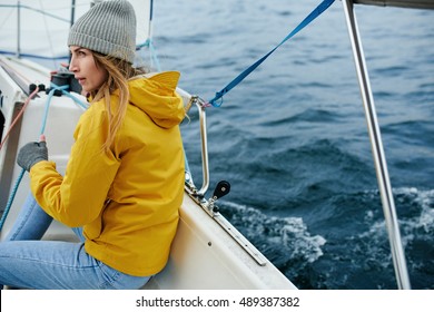 Young Strong Woman Sailing The Boat