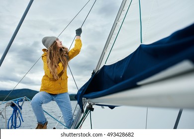 Young Strong Woman Sailing The Boat