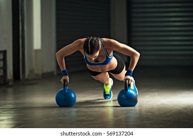 Young Strongwoman Is Doing Push-ups By Kettle Bell.