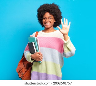 Young Student Afro Woman Smiling And Looking Friendly, Showing Number Five Or Fifth With Hand Forward, Counting Down