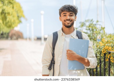 Young student Arabian man at outdoors smiling a lot - Powered by Shutterstock