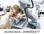 Young student assembling robotic arm in a lab environment. Concept of STEM education, youth in robotics, hands on learning, future engineers and early exposure to automation technology.