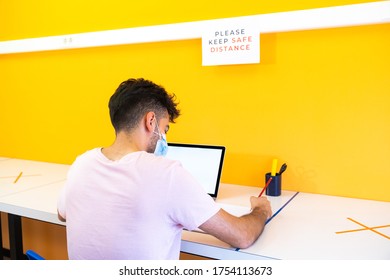 Young Student Boy Doing His Homework At School With The Computer In The New Normal. Back To School Concept. Please Maintain A Safe Distance.