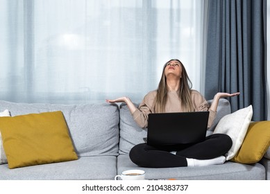 Young Student Or Business Woman Sitting At Home Covering Her Ears With Hands Because She Cant Study Or Work On Her Laptop Computer From Loud Noise Coming From Apartment Above. 