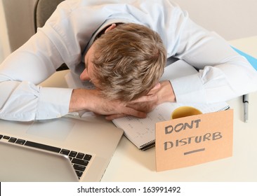 Young Student Or Businessman Overwhelmed Sleeping With Dont Disturb Sign Written On Cardboard