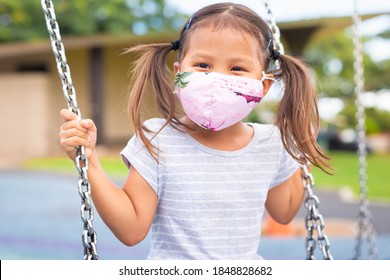 Young Student Child Wearing A Mask Playing At The Park Playground.