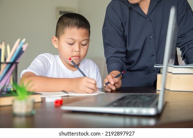 Young Student Distance Learning Virtual Distance Online Class On Video Call Virtual Lesson With Mother, Studying At Home Using Laptop Computer. Parent Or Tutor Teaching Child Boy With Remote Education