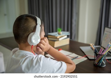 Young Student Distance Learning Virtual Distance Online Class On Video Call Virtual Lesson, Technology Studying At Home Using Laptop Computer. Parent Or Tutor Teaching Child Boy With Remote Education.