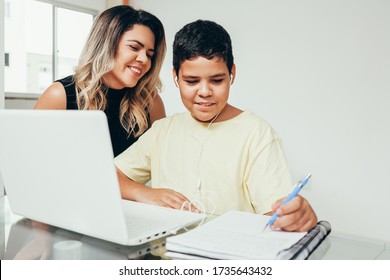 Young Student Doing Homework At Home With Laptop Helped By His Mother. Mom Teaching His Son. Education, Family Lifestyle, Homeschooling Concept