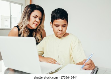 Young Student Doing Homework At Home With Laptop Helped By His Mother. Mom Teaching His Son. Education, Family Lifestyle, Homeschooling Concept