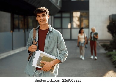 Young student in front of university building looking at camera. - Shutterstock ID 2269023225