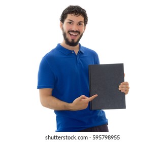 Young student holding and pointing at a black cover notebook. Space for text. Young man wearing blue polo shirt, white background, copy space. - Powered by Shutterstock