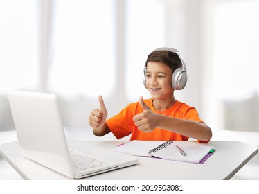 Young Student Or Kid Attending Online School Using Computer Studying Using A Laptop.